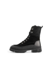 Zwarte veterschoen van suede en leer, met een chunky rubberen zool en metalen oogjes, en een zachte, hoogwaardige kraag van bont.