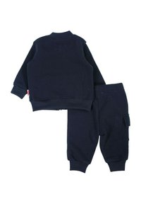 Ensemble pour enfants composé d'un sweat-shirt et d'un pantalon bleu marine. Le sweat-shirt présente un col rond côtelé ; le pantalon est doté d'une poche latérale et de poignets côtelés. Texture de tissu doux.