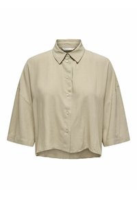 Kortærmet, knappet skjorte i let beige stof. Har en klassisk krave, løs pasform og en glat tekstur uden synlige mønstre.