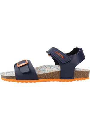 Navy blue sandal with adjustable strap, orange accents, and cork sole. Patterned insole features light blue and orange designs.