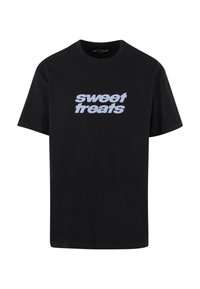 Black cotton t-shirt featuring "sweet treats" printed in a contrasting light blue font across the chest. Short sleeves and crew neck design.