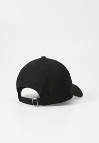 Black cotton baseball cap featuring a curved brim, adjustable strap at the back, and ventilation holes on a smooth surface.