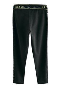 Zwarte leggings met een textuur, inclusief een gouden logo op de tailleband en zijaccenten. Slim fit ontwerp met taps toelopende benen.