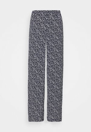 Pantalon large bleu marine avec motif à pois blancs irréguliers et taille élastique, présenté sur fond uni.