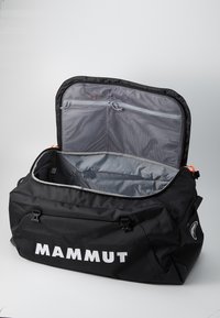 Black duffel bag with logo, zipper closure, and gray interior. Features two mesh pockets inside. Made of durable fabric with a textured finish.