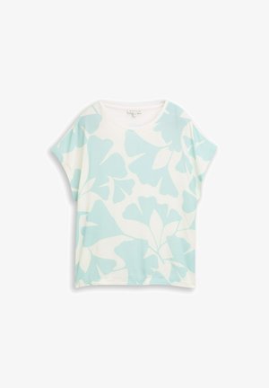 Biała koszula z krótkim rękawem o luźnym kroju, zdobiona dużymi jasnoniebieskimi abstrakcyjnymi wzorami kwiatowymi.