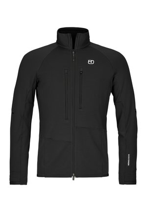 Schwarze Langarmjacke mit Reißverschluss und hohem Kragen, zwei vertikalen Brusttaschen mit Reißverschlüssen und Logo auf der linken Brustseite.