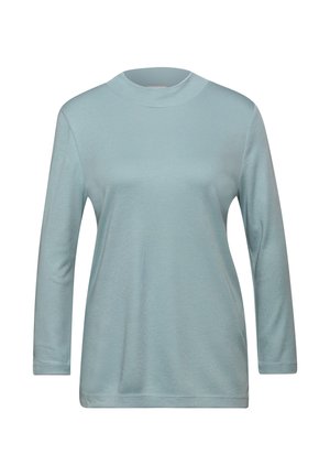 Helles blaues Langarmshirt mit hohem Ausschnitt. Aus weichem Stoff gefertigt, hat es eine lockere Passform und einen geraden Saum. Schlichte Ausführung, ohne Muster oder Akzente.