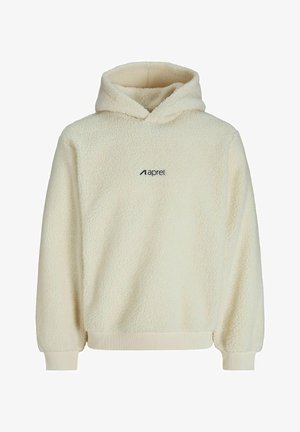 Kreminės spalvos pūkinis džemperis su tekstūruotu audiniu, priekinė kišenė, susiraukšlėję rankogaliai ir juodas logotipas kairėje krūtinės pusėje.