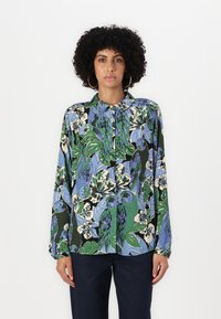 Long-sleeved button-up shirt in a multicolored floral and parrot print. Fabric features a smooth texture; colors include green, blue, and black.