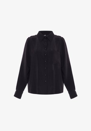 Chemise noire à manches longues avec un col, poche avant, fermeture à boutons et tissu texturé subtil. Détails en boutons dorés.