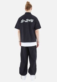 Megaman FREIZEI SET - Trousers - schwarz
