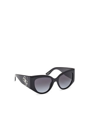 Lunettes de soleil noires avec une large monture, verres gris dégradés et éléments décoratifs comportant un accent à motif sur la branche.