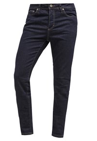 Jeans de mezclilla azul marino con corte ajustado. Presentan cinco bolsillos, trabillas para cinturón y costuras contrastantes en amarillo. Textura suave y diseño clásico.