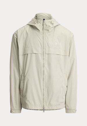 Lys beige hættejakke med lynlås foran, justerbare snore på hætten, lange ærmer med trykknapmanchetter og sidelommer.