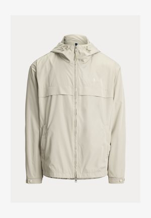 Lichtbeige jas met capuchon en ritssluiting aan de voorkant, verstelbare trekkoorden op de capuchon, lange mouwen met drukknoopmanchetten en zijzakken.