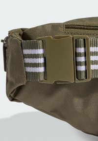 Bolso de cintura verde oliva hecho de una tela duradera con un acabado texturizado. Incluye una hebilla de plástico y una correa ajustable a rayas para un ajuste seguro.