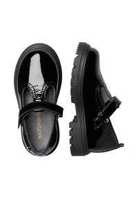 Scarpe in vernice nera con design Mary Jane, dotate di una fascia in Velcro, punta tonda e suola spessa in gomma dal design texture.