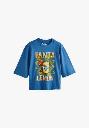 Blue short-sleeve T-shirt with Fanta Lemon graphic featuring a yellow soda can, green leaves, and a red and blue parrot.