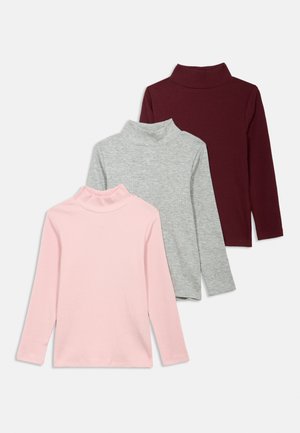 Three long-sleeve turtlenecks in pink, grey, and burgundy colors. Made of ribbed fabric, featuring fitted collars and soft texture.