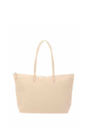 Sac fourre-tout en cuir beige avec double anses d'épaule et fermeture éclair supérieure, design minimaliste, adapté à un usage quotidien.