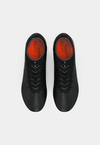 Black athletic shoes with a smooth texture, featuring red accents on the insoles and a woven design on the sides, laced with dark grey laces.