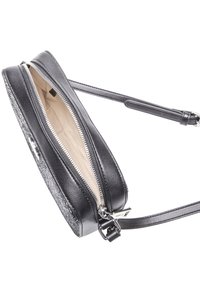 Black leather crossbody bag with a sleek design, zippered closure, and a textured side panel. Includes an adjustable strap and beige interior.