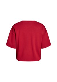 Červené tričko s krátkymi rukávmi, vo voľnom strihu a s okrúhlym výstrihom. Mäkká tkanina, jednoduchý dizajn, s uvoľneným strihom a širokými rukávmi.