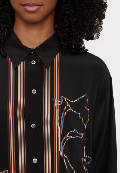 Black shirt with multicolored vertical stripes and an abstract graphic design. Features a button-up collar and smooth fabric texture.