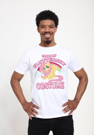 White cotton t-shirt featuring a colorful cartoon character with pink hair, yellow wings, and bold text stating "THIS IS MY FLUTTERSHY COSTUME."