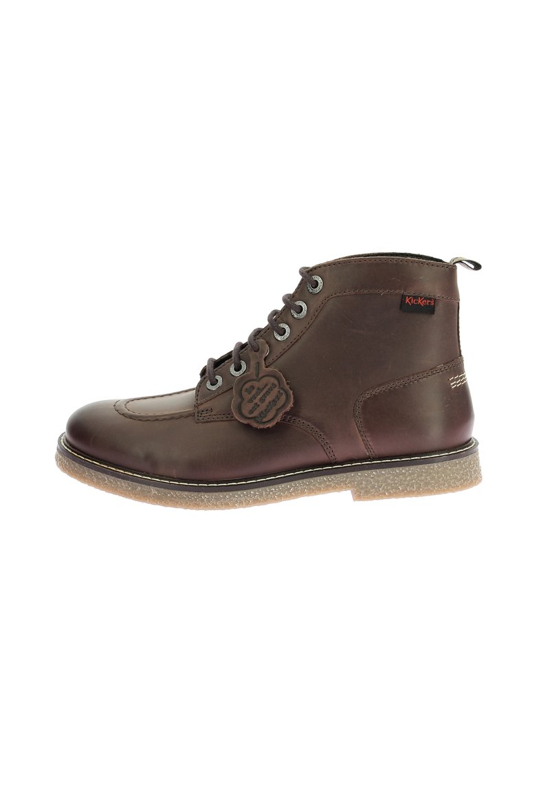 Bruine leren enkelboots met vetersluiting, textuur zolen en rubberen buitenzool. Bevat een decoratief label aan de zijkant.