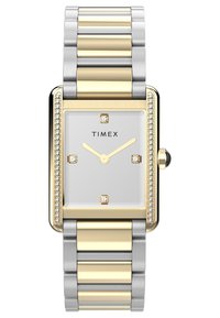 Montre rectangulaire en acier inoxydable et ton or avec un cadran blanc, quatre repères ressemblant à des diamants et une lunette décorative en pierres précieuses.