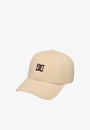 Casquette de baseball en polaire beige avec une visière courbée et un écusson marron à logo DC au centre devant.