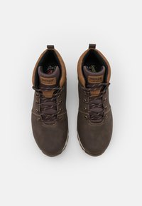 Brown lace-up ankle boots with a smooth leather finish, suede accents, and padded collar. Features metal eyelets and reinforced stitching.