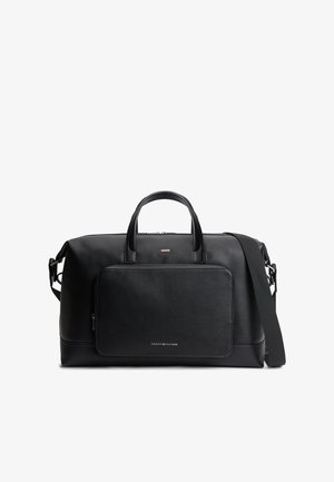 Czarna teksturowana skórzana torba podróżna z dwoma uchwytami, odpinanym paskiem na ramię, przednią kieszenią na zamek oraz małym logo Tommy Hilfiger.