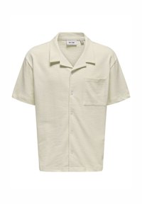 Camicetta a maniche corte di colore giallo pallido con colletto, realizzata in tessuto testurizzato, dotata di una tasca sul petto sinistro e bottoni bianchi lungo la parte anteriore.