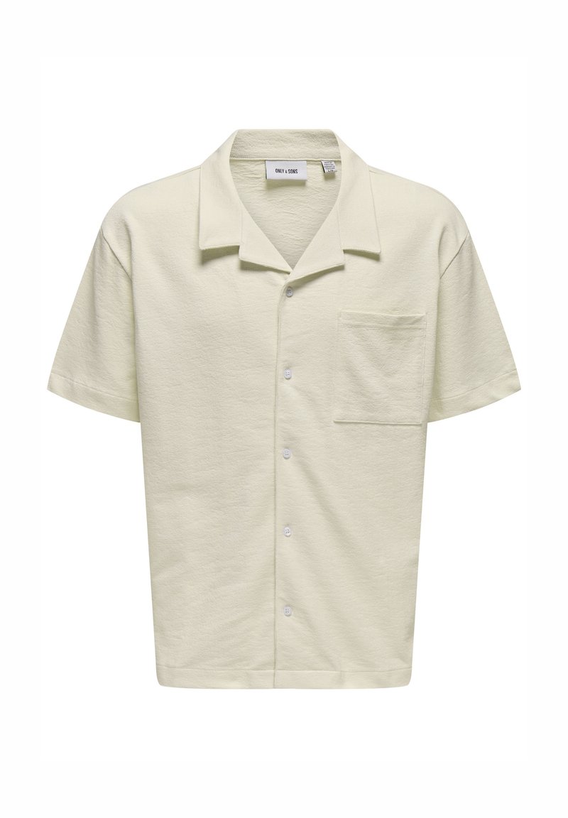 Camicetta a maniche corte di colore giallo pallido con colletto, realizzata in tessuto testurizzato, dotata di una tasca sul petto sinistro e bottoni bianchi lungo la parte anteriore.