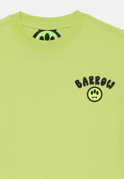 Lime green t-shirt made of cotton with a crew neck. Features black text "BARROW" and a graphic smiley face logo on the chest.