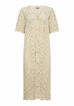 Gaiši beidzis adīts kardigāns ar īsām piedurknēm, ar viļņotu kaklu un sarežģītu atklāto lapu rakstu, ar pogu priekšpusi.