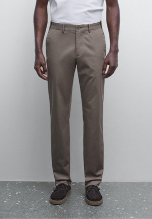 Brown chinos made from cotton blend, featuring a straight-leg design, front pockets, a single button closure, and a smooth texture.