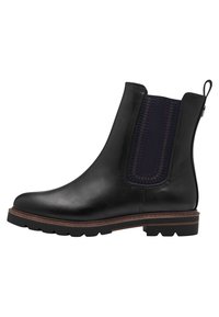 Botte de cheville en cuir noir avec un bout arrondi, panneau latéral élastique en violet foncé et une semelle épaisse et robuste avec un léger talon.