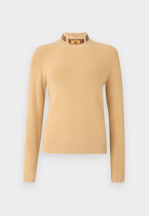 Knit sweater in light beige with long sleeves and a ribbed texture. Features a high collar with a brown accent and a gold clasp.