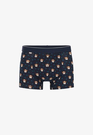 Boxer shorts de couleur navy en coton extensible, avec un motif répétitif de visages de chiens de dessin animé et de triangles bleus. Taille contrastante.