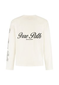 Long-sleeve cream shirt made of cotton. Features black text "Pure Path" and "OWN THE JOURNEY" on the back and text along the sleeve.