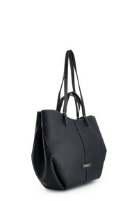 Black leather tote bag with dual handles, textured surface, and contrasting white stitching. Features a gold logo accent on the front.