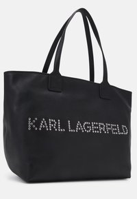 Zwart lederen tote bag met gestructureerd oppervlak en dubbele handvatten. "KARL LAGERFELD" is zilvergestikt aan de voorkant.