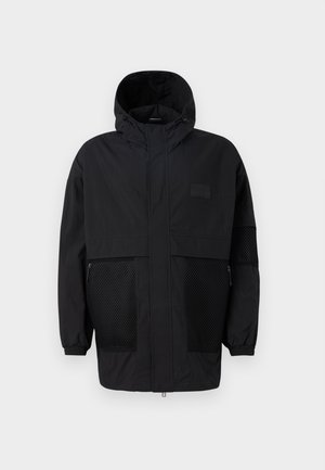 Black hooded jacket made from lightweight fabric, featuring mesh panels, a front zipper, and elastic cuffs for adjustable fit.