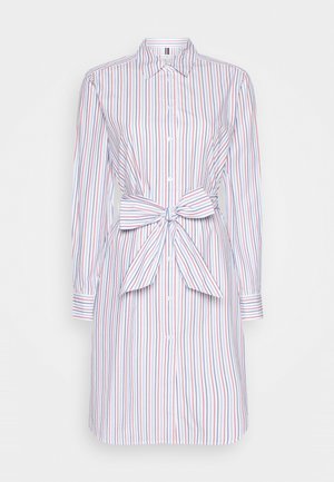 Striped shirt dress in blue, red, and white. Features a collar, long sleeves, button front, and a tied waist accent. Smooth fabric texture.