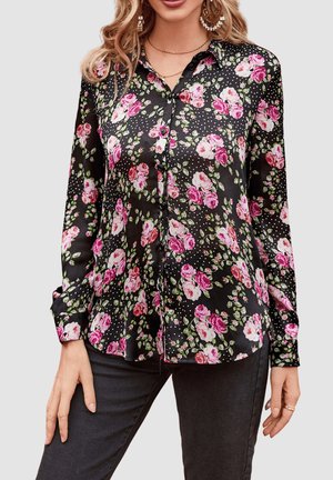 Blusa negra con estampado de flores, que presenta rosas rosas y hojas verdes, hecha de un tejido suave con cierre de botones en la parte delantera y mangas largas.
