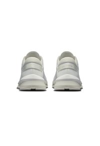 White athletic shoes with a smooth upper, textured back panel, and serrated sole. Features minimal branding and a sleek, modern design.